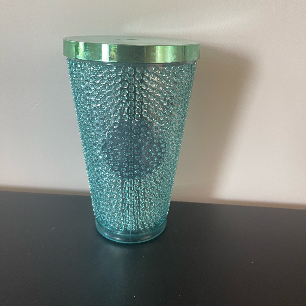 Green studded Starbucks cup